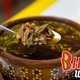 bowl of birria with spoon lifting up the meat